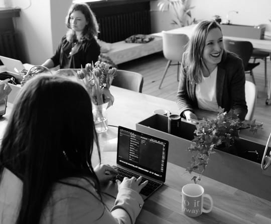 Three
        women working in an office